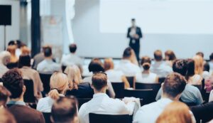 Business speaker giving a talk at business conference event.