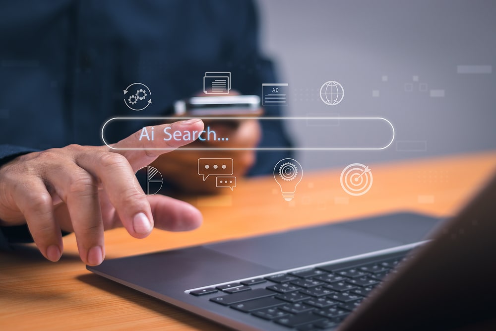 Using AI search for information or search engine optimisation, SEO, Man hand tapping on virtual search bar while using laptop.