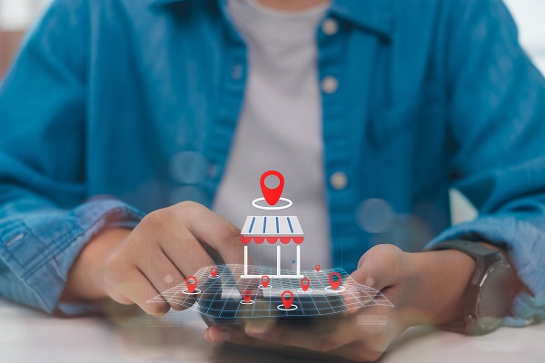 Person holding smartphone with 3D map and location pins, highlighting local store search, location-based marketing, and smart navigation for digital business and Local SEO optimisation.